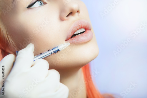 Woman Geting an Injection in her Lips in Beauty Salon