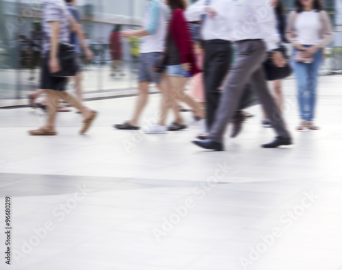 Abstract blurred people are walking in the city © ArtBackground
