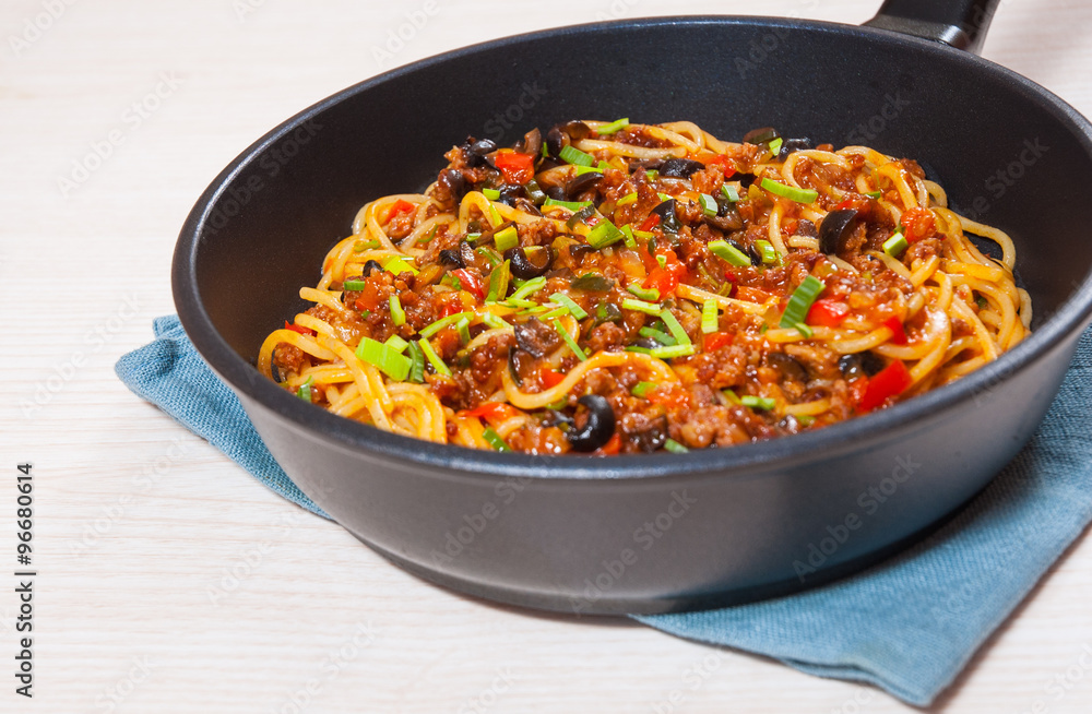 spaghetti with vegetables and minced meat in a frying pan spaghetti with vegetables and minced meat in a frying pan