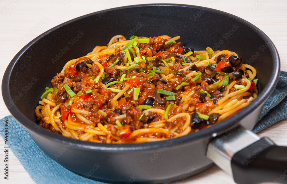 spaghetti with vegetables and minced meat in a frying pan spaghetti with vegetables and minced meat in a frying pan