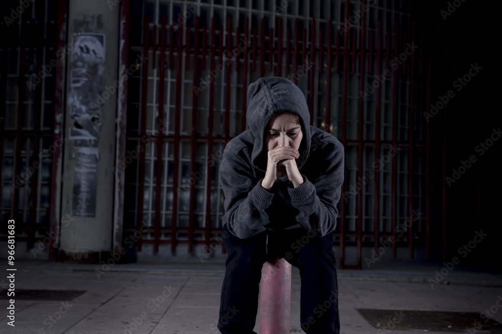 Naklejka premium sad woman alone on street suffering depression desperate and helpless wearing hoodie