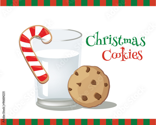 A candy cane cookie hanging on a glass of milk.