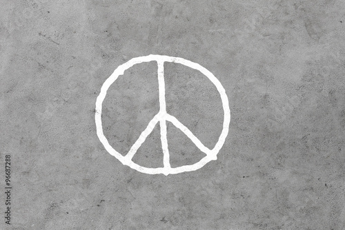 peace sign drawing on gray concrete wall photo