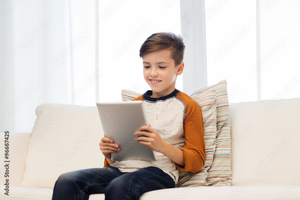 smiling boy with tablet computer at home smiling boy with tablet computer at home
