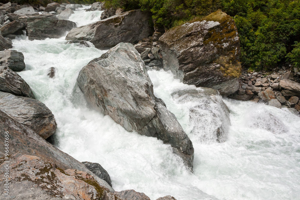 Colorful Rocks in White Water - New Zealand, Mt Aspiring National Park Colorful Rocks in White Water - New Zealand, Mt Aspiring National Park