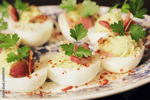 deviled eggs appetizer with avocado and bacon