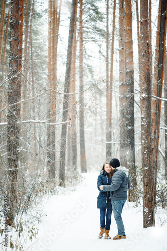 Young Couple Embracing in Winter Forest