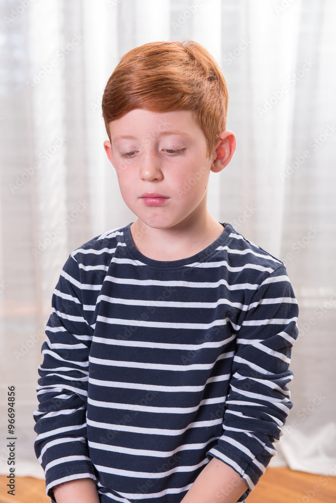 Portrait small boy sad and looking down Portrait small boy sad and looking down