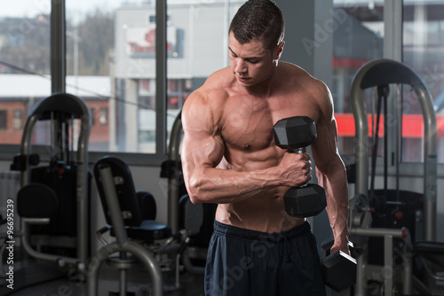 Bodybuilder Exercise With Dumbbells