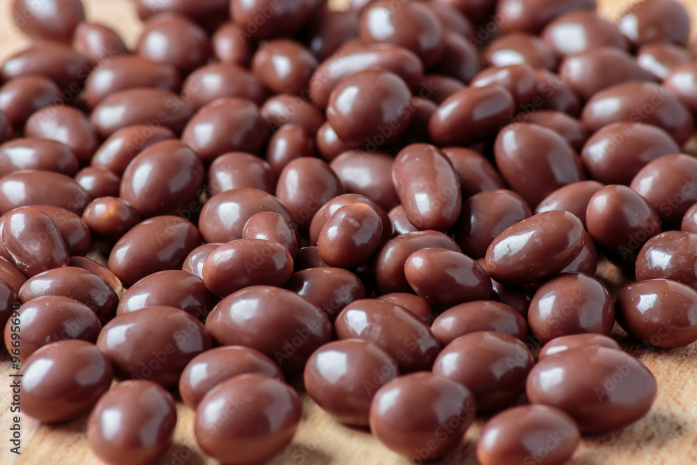 Chocolate dragee on wooden background Chocolate dragee on wooden background