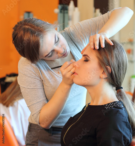  Professional Make-up artist doing glamour model makeup at work 