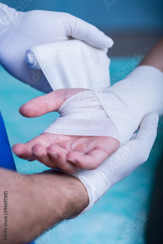 Strapping patient's arm