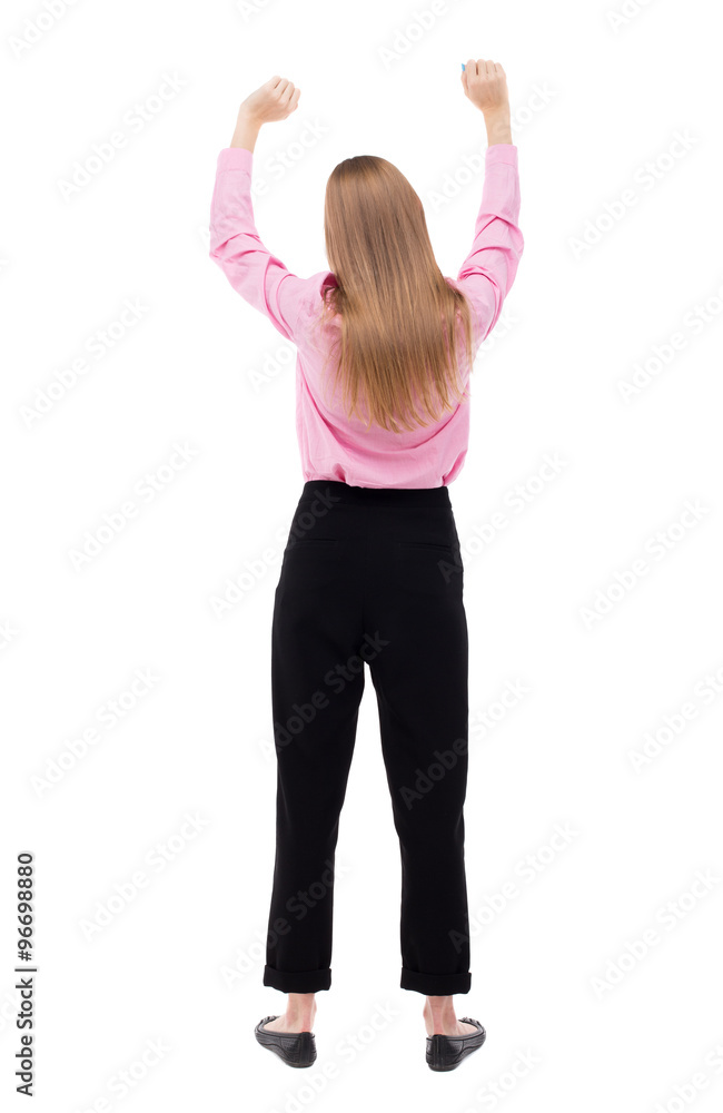 Back view of business woman. Raised his fist up in victory sig Back view of business woman. Raised his fist up in victory sig