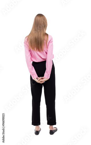 back view of standing young beautiful woman.