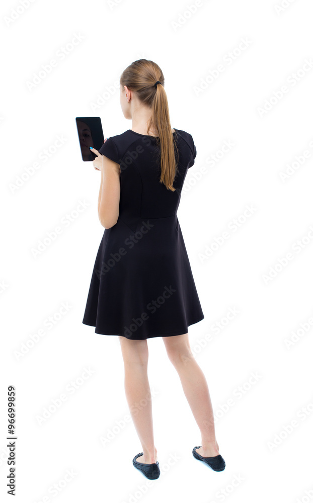 back view of standing young beautiful girl with tablet computer back view of standing young beautiful girl with tablet computer