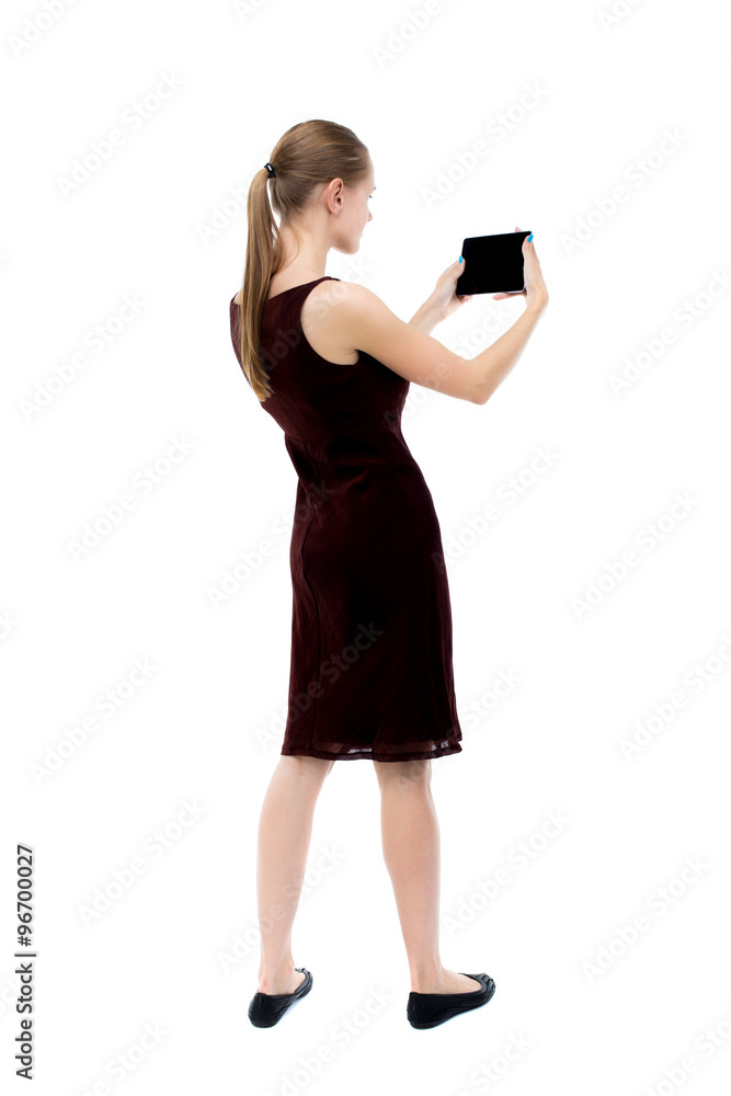 back view of standing young beautiful girl with tablet computer back view of standing young beautiful girl with tablet computer
