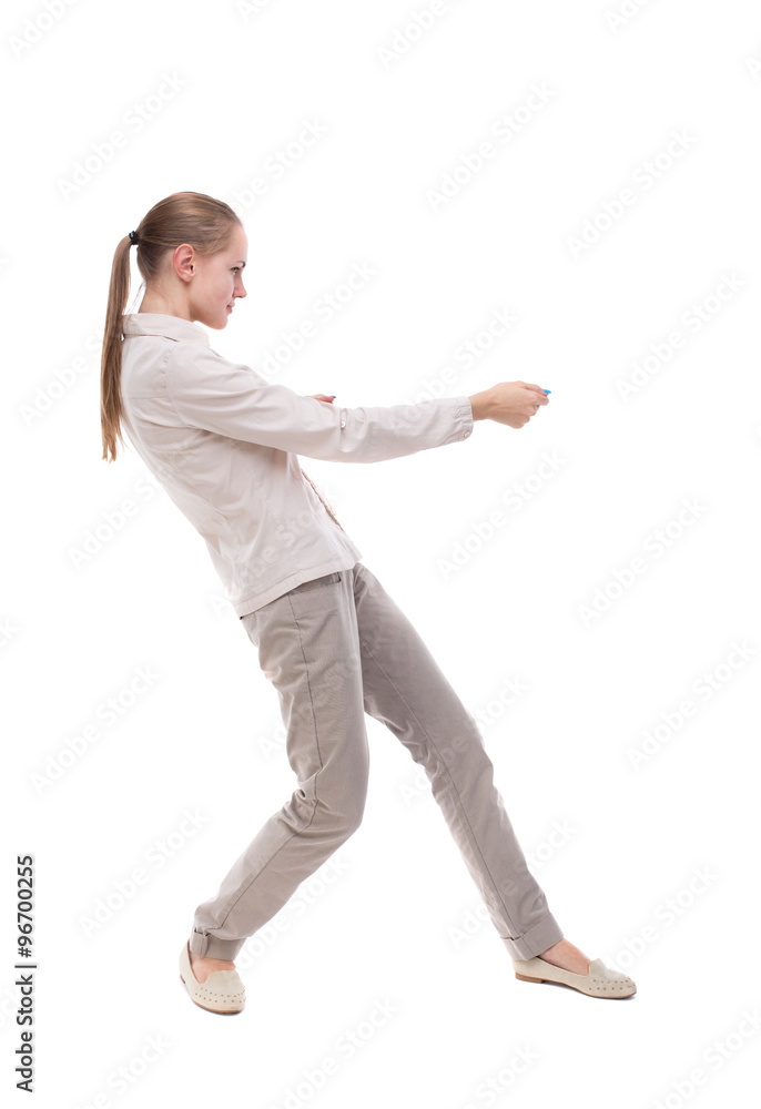 back view of standing girl pulling a rope from the top or cling back view of standing girl pulling a rope from the top or cling