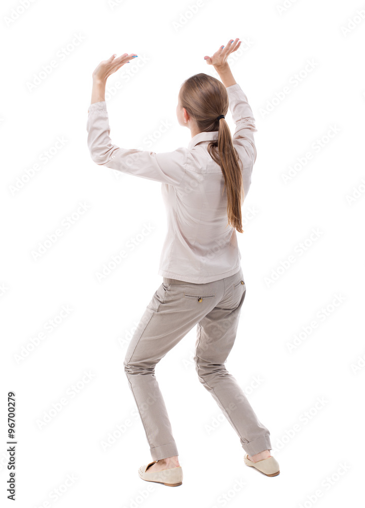 back view of woman protects hands from what is falling from abo back view of woman protects hands from what is falling from abo