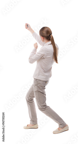 back view of standing girl pulling a rope from the top or cling