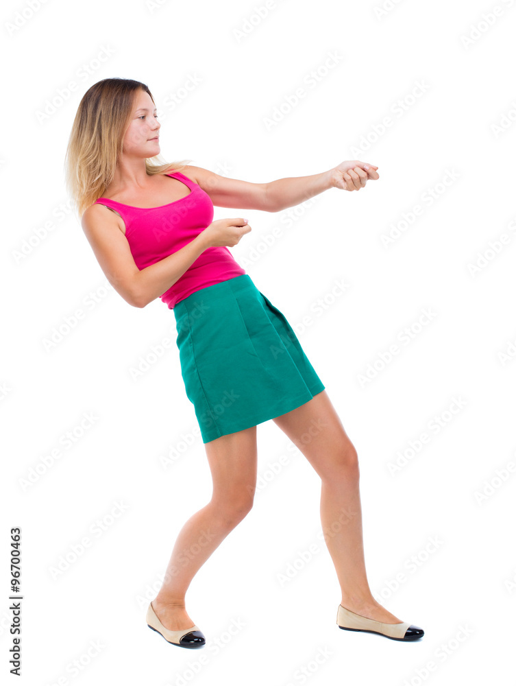 back view of standing girl pulling a rope from the top or cling back view of standing girl pulling a rope from the top or cling