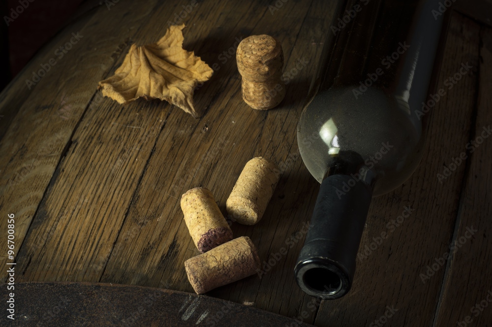 Wine bottle with barrel and corks