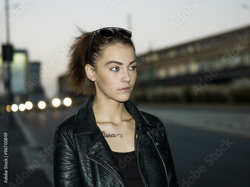 Beautiful girl portrait walking in the city at sundown