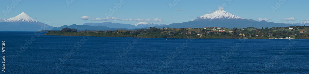 Snow capped Volcanoes Osorno (2,652 metres) and Calbuco (2,105 metres) on the edge of Llanquihue Lake in Southern Chile. Viewed from Puerto Varas.
