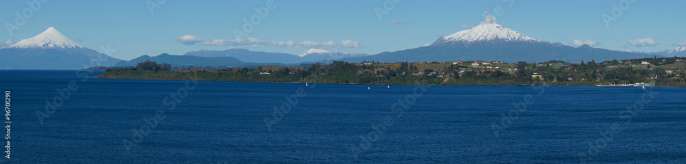Snow capped Volcanoes Osorno (2,652 metres) and Calbuco (2,105 metres) on the edge of Llanquihue Lake in Southern Chile. Viewed from Puerto Varas. Snow capped Volcanoes Osorno (2,652 metres) and Calbuco (2,105 metres) on the edge of Llanquihue Lake in Southern Chile. Viewed from Puerto Varas.