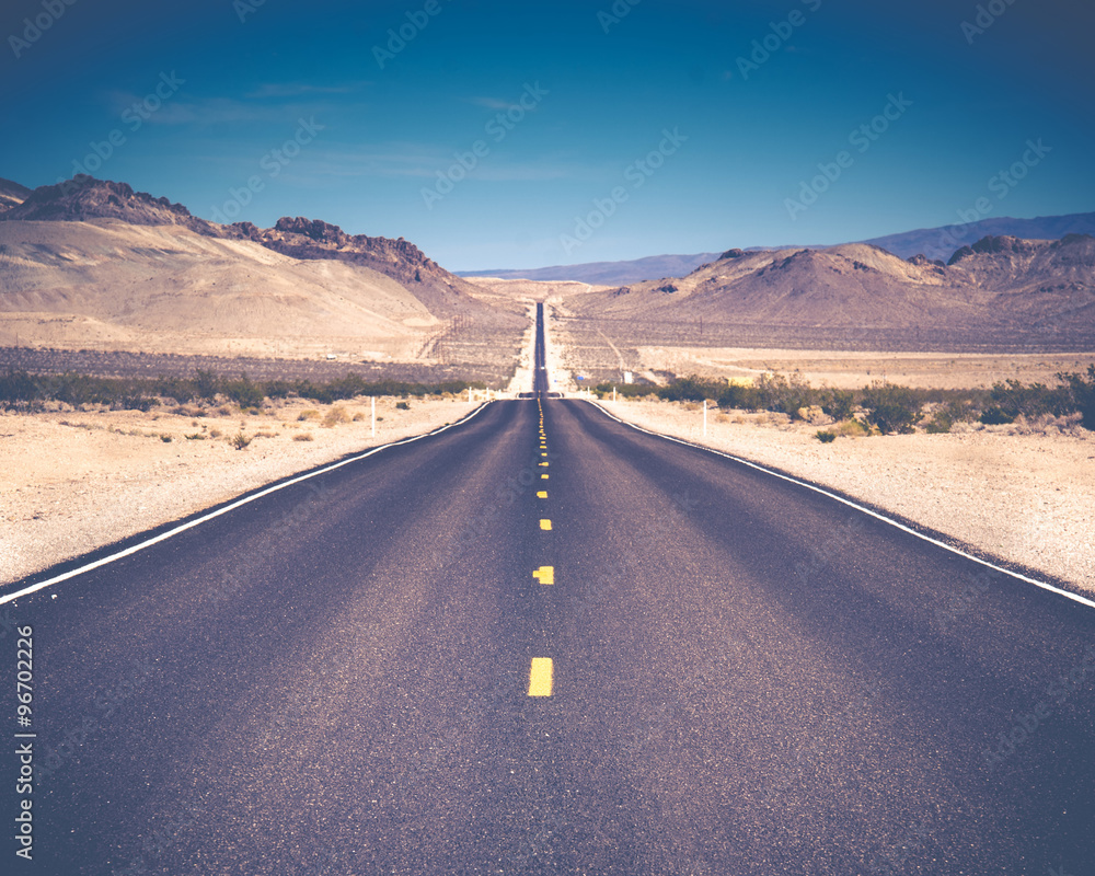 Open Road and possibilities. Road in Death Valley National Park. Artistic Instagram style processing.