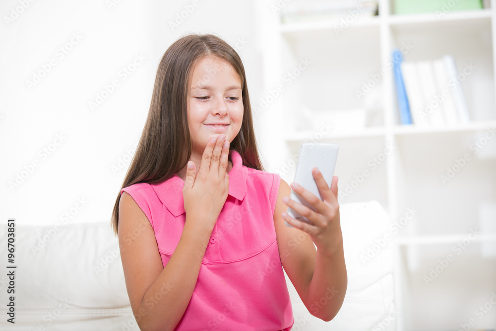 Smiling deaf girl talking using sign language on the smartphone's cam Smiling deaf girl talking using sign language on the smartphone's cam