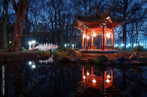 Traditional Chinese pavilions in Lazienki Park in Warsaw at nigh