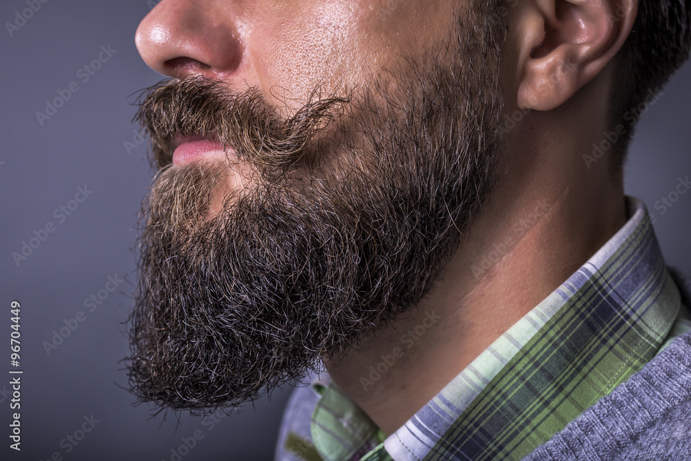 Closeup of a man beard and mustache over gray background