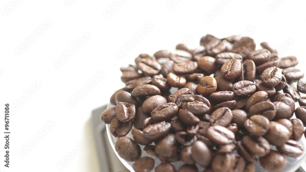 Rotating fresh coffee beans with white copy space Rotating fresh coffee beans with white copy space