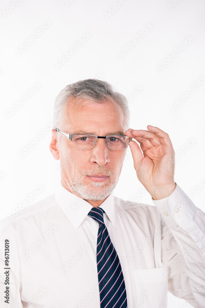 Old businessman holding his glasses Old businessman holding his glasses