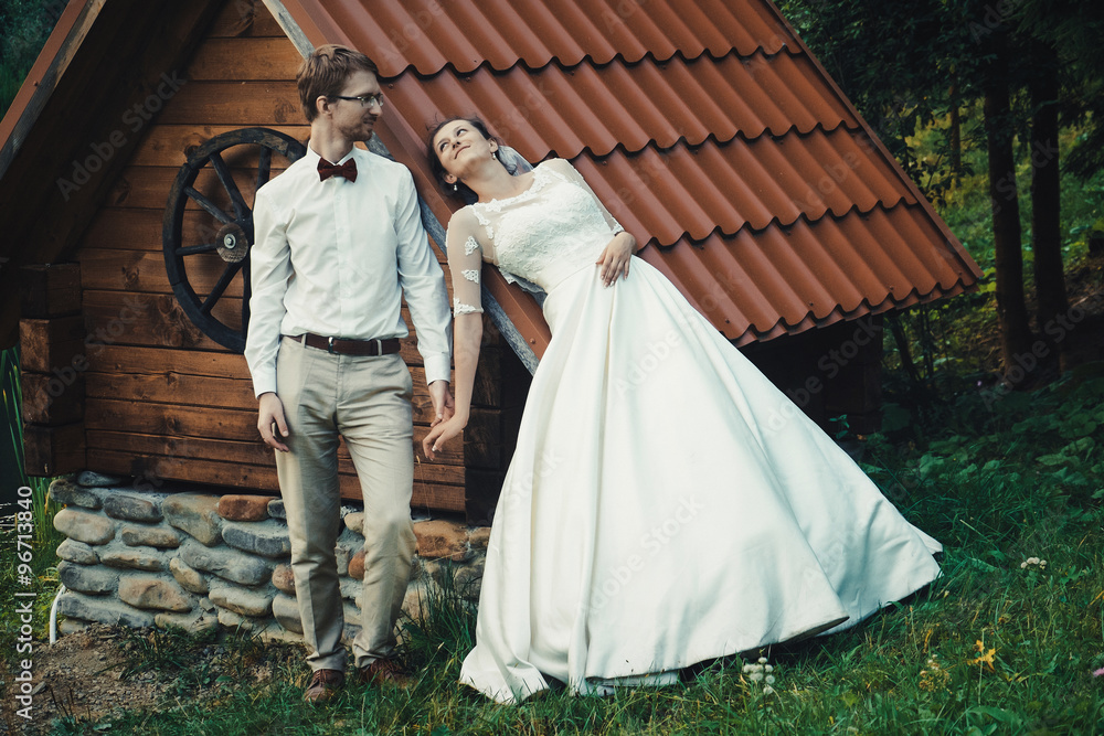 A young bride and groom standing together outdoor