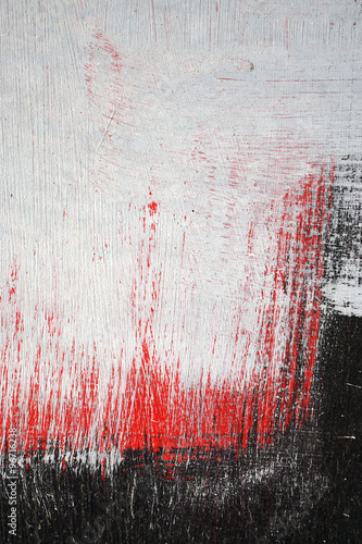 Brushstroke with white,black and red paint  on dusty metal