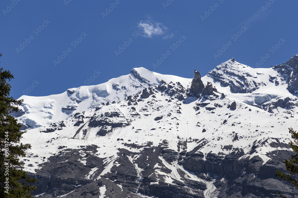 View of mountain rocks and ice-capped Swiss Alps near Oeschinensee Lake, Kandersteg, Switzerland