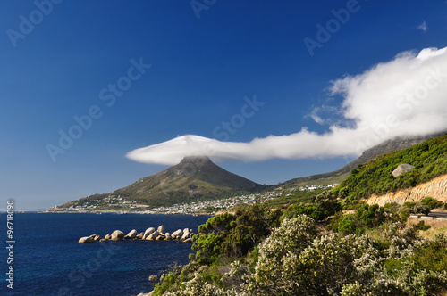 Stunning view of Lion's Head with a lenticularis cloud covering the top. You can also see Camps Bay and Clifton. Cape Town, South Africa.