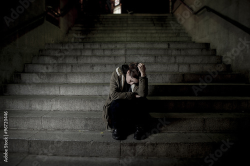 Obraz na plátně sad woman alone on street subway staircase suffering depression looking looking