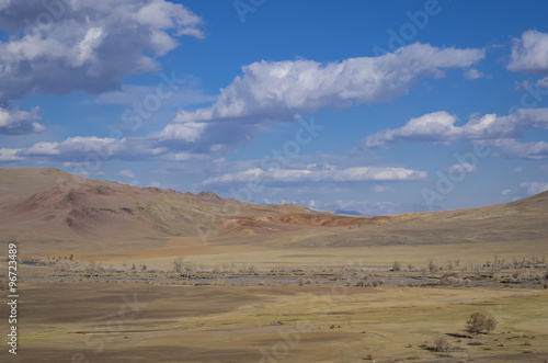 Hills on Mars. Sunny summer day, the hills in the desert land, mountains in the distance