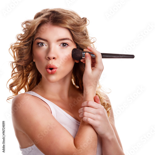 Girl with curly hair straightens makeup brush.