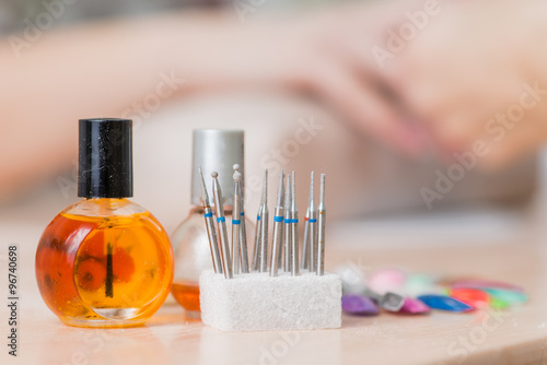 bottles and tools for manicure after work close-up in nail salon  Shallow DOF 