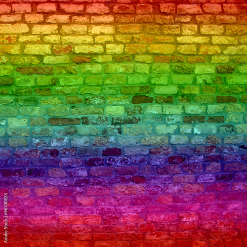Concept or conceptual colorful painted or graffiti old vintage grungy brick wall texture