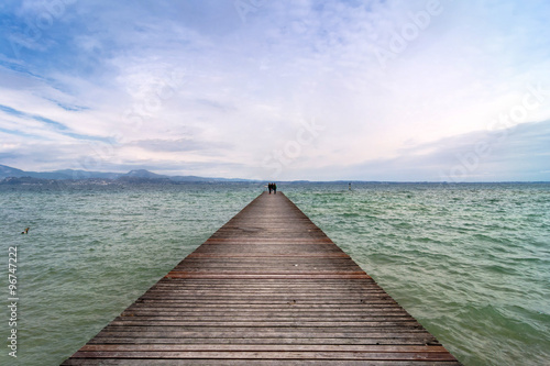 wooden pier and sky over Garda lake - Italy