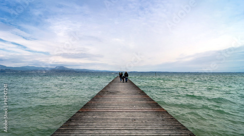 wooden pier and sky over Garda lake - Italy