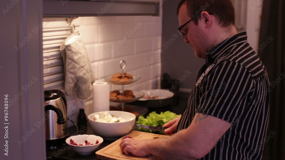 Man cut red onions on a wooden cutting board Man cut red onions on a wooden cutting board