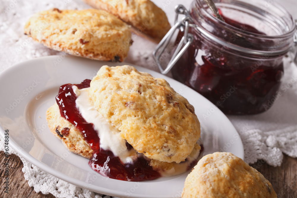 British scones with jam and whipped cream close-up. Horizontal
British scones with jam and whipped cream close-up. Horizontal