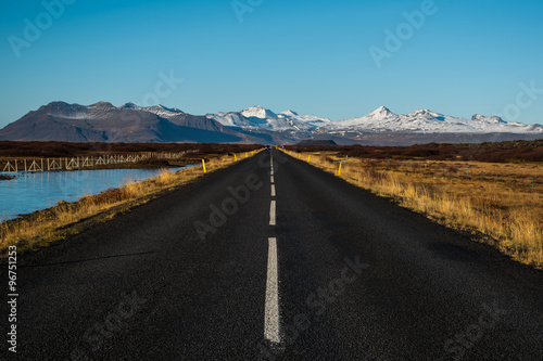 Highway Straight Road and snowcapped mountains