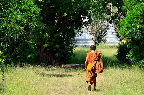 Monk walking at Prasat Nakhon Luang Temple © tuayai