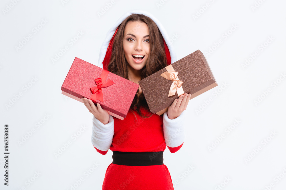 Amazed lovely excited girl in santa claus costume holding presents Amazed lovely excited girl in santa claus costume holding presents